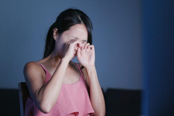 Woman use of laptop computer and feeling dry of eye